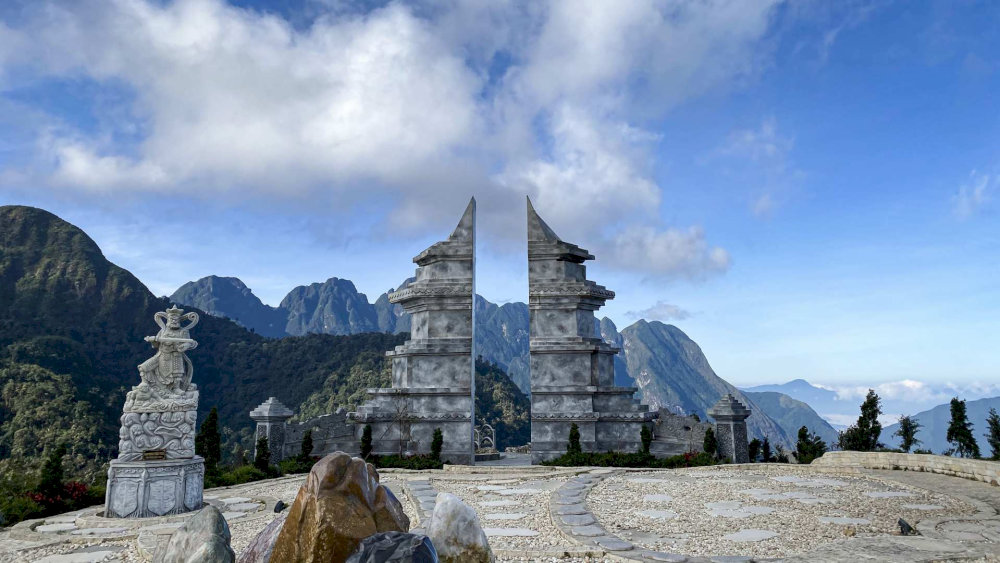 Framed by ancient architecture, the Heaven Gate opens to a breathtaking view of Sapa’s sky and mountains
